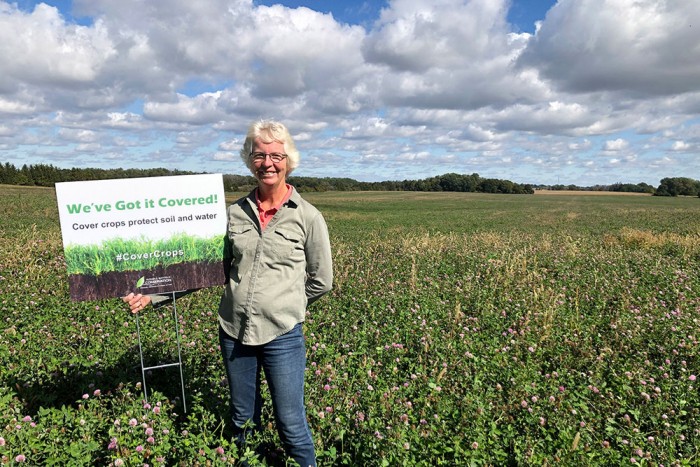 SIGNS RECOGNIZE COVER CROP PLANTING BENEFITS – Margaret Kroes, who farms with her husband, Jack, near Clinton, Ontario, is one of the local agricultural producers planting cover crops. Here, Margaret stands beside a new ‘We’ve Got it Covered!’ sign.