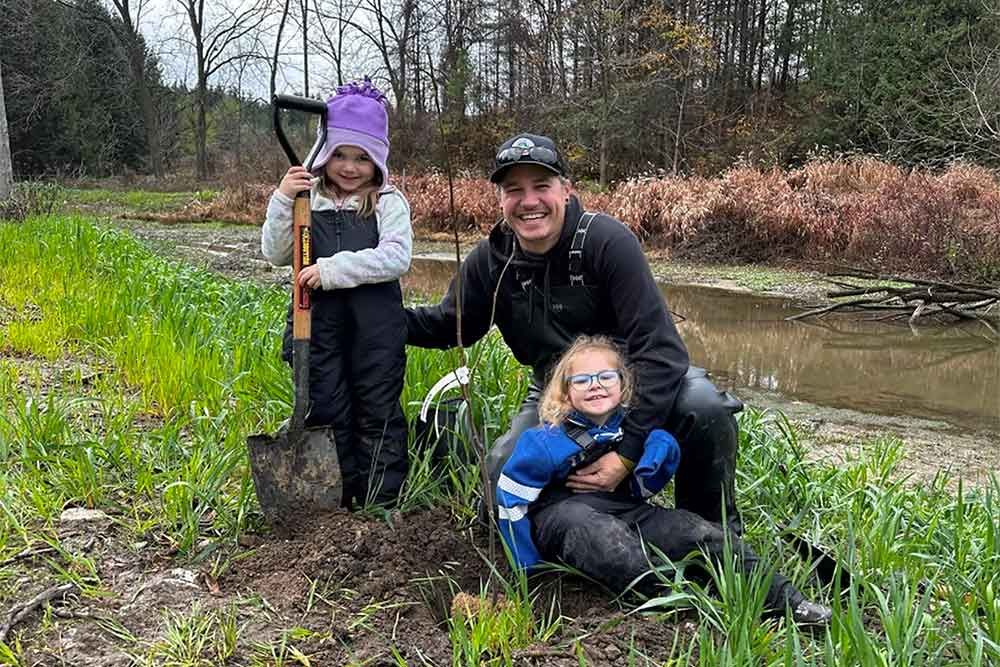 Mike Sklad and daughters at community dam restoration planting at Naftel’s Creek.